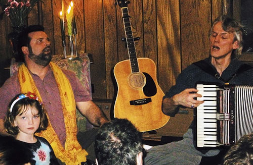 David Ballman singing and David Schmit playing the accordian for some children